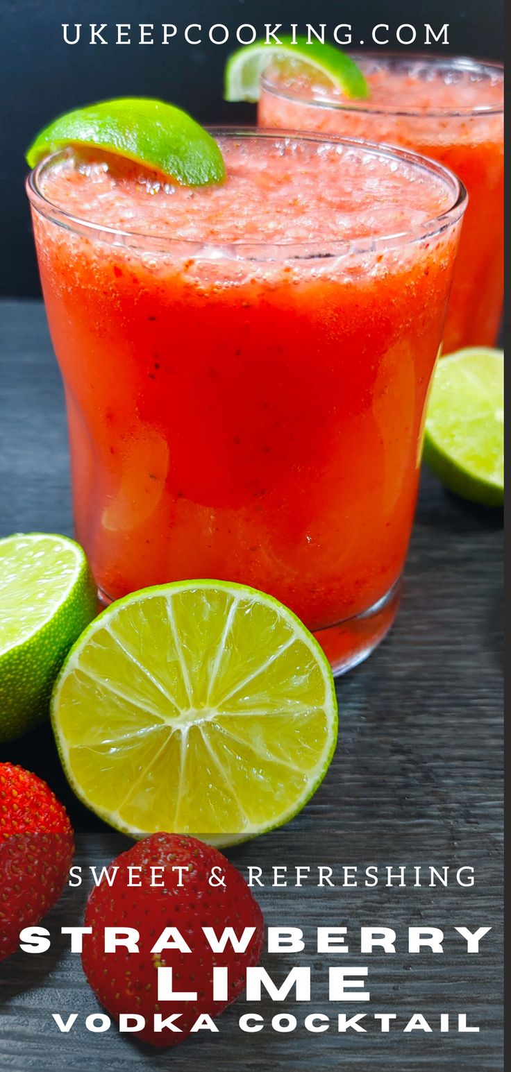 two glasses filled with strawberry lime vodka next to strawberries and limes