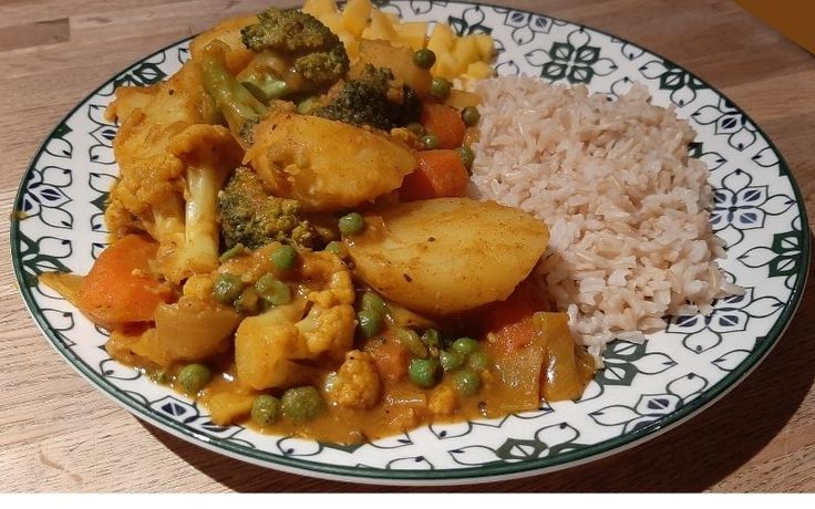 a white and green plate topped with rice and veggies