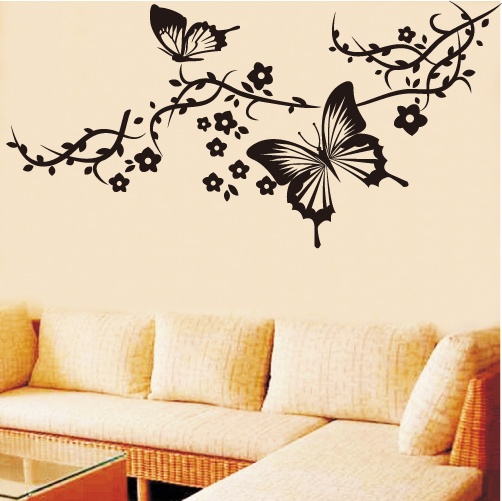 a living room filled with furniture and a butterfly wall decal