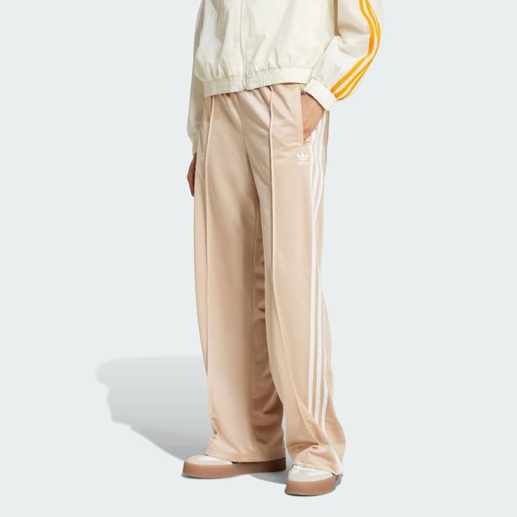 Represent the adidas Originals lifestyle in all its authentic glory. These iconic Firebird track pants are built for comfort, movement and long-term wear, thanks to their super-soft tricot build. 3-Stripes down the legs and an embroidered Trefoil logo add an unmistakable heritage flavor. Casually confident and classically cool, these relaxed pants are a must-have in any wardrobe. Made with 100% recycled materials, this product represents just one of our solutions to help end plastic waste. Adidas Beige, Weekend Fits, Adidas Firebird, Adidas Rivalry Low, Beige Adidas, Adidas Adicolor, Adidas Tracksuit, Tricot Fabric, Polo Sport Ralph Lauren