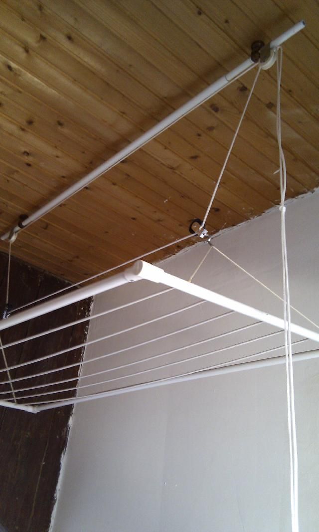 an overhead view of a wooden ceiling with white clothes pins hanging from it's sides