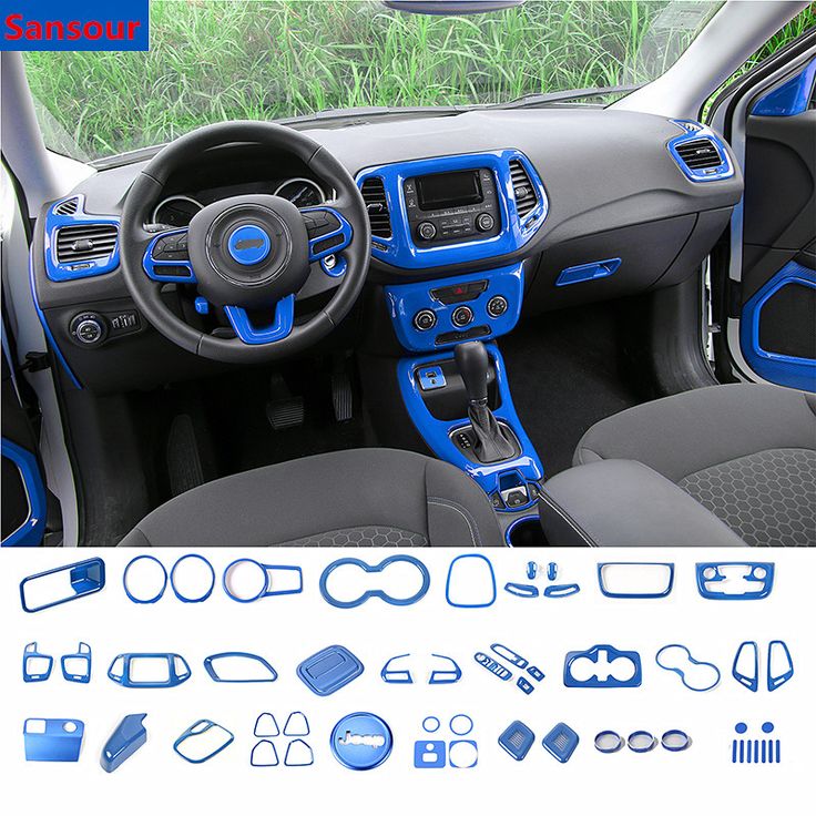 the interior of a car with blue trims and dash stickers, including steering wheel