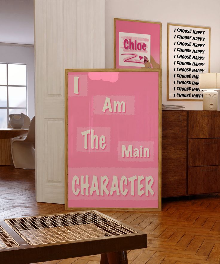 a pink sign that says i am the main character next to a wooden bench in a room