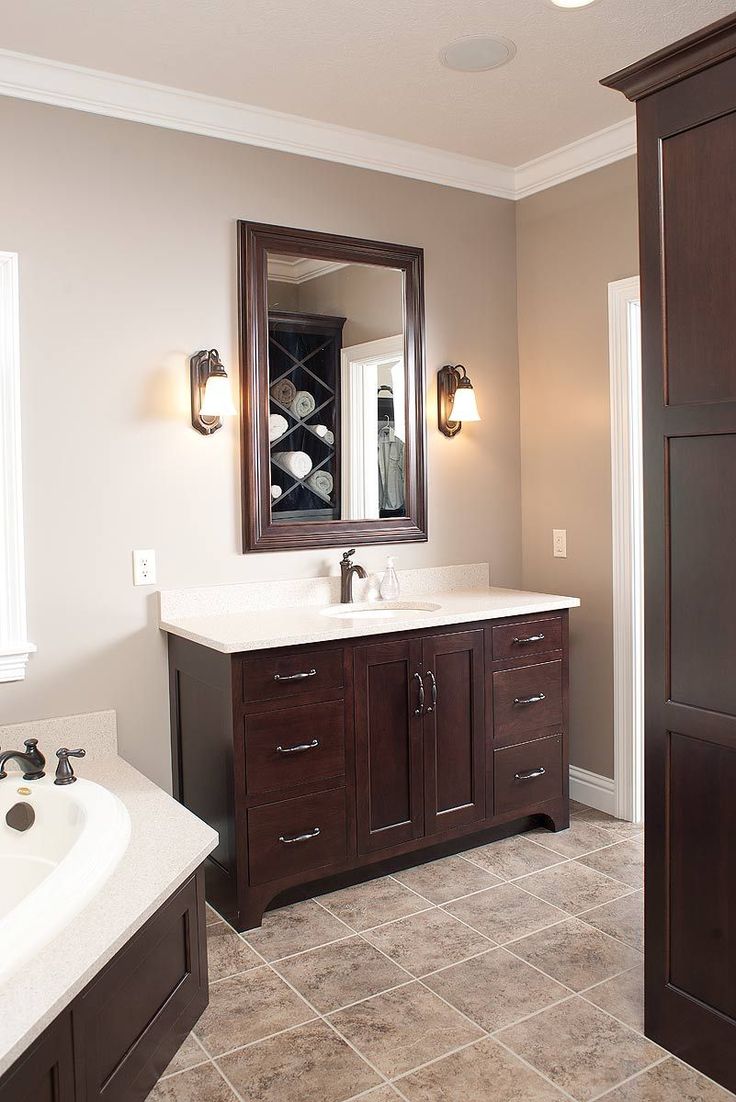 a bathroom with two sinks and a large mirror on the wall next to an open door