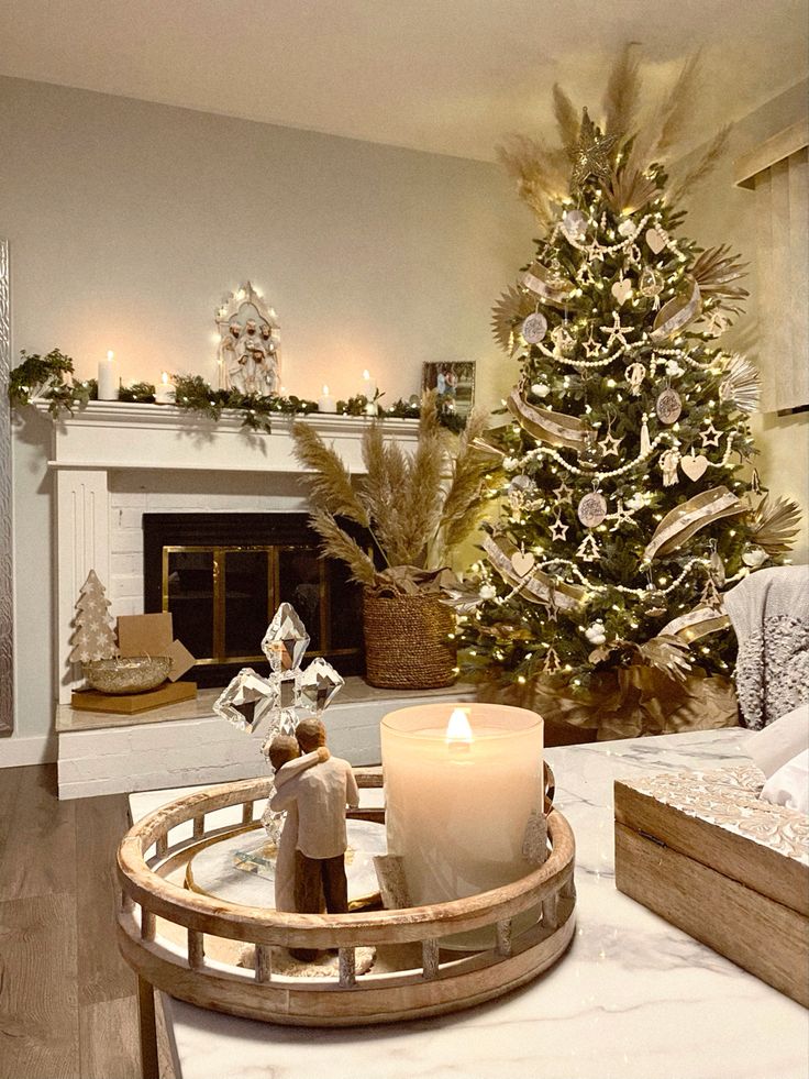 a living room with a christmas tree in the corner and a lit candle on a tray