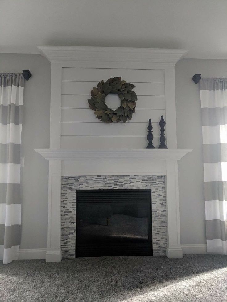 a living room with a fire place and curtains