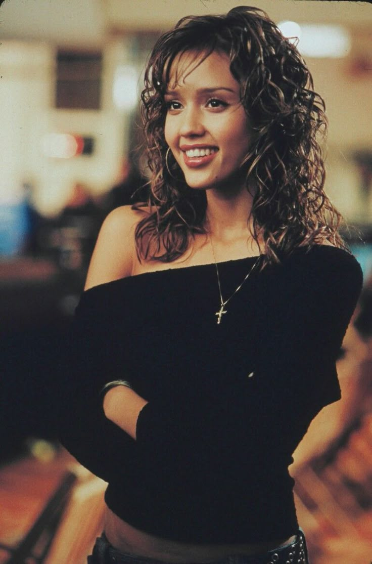 a woman in black shirt and jeans posing for a photo