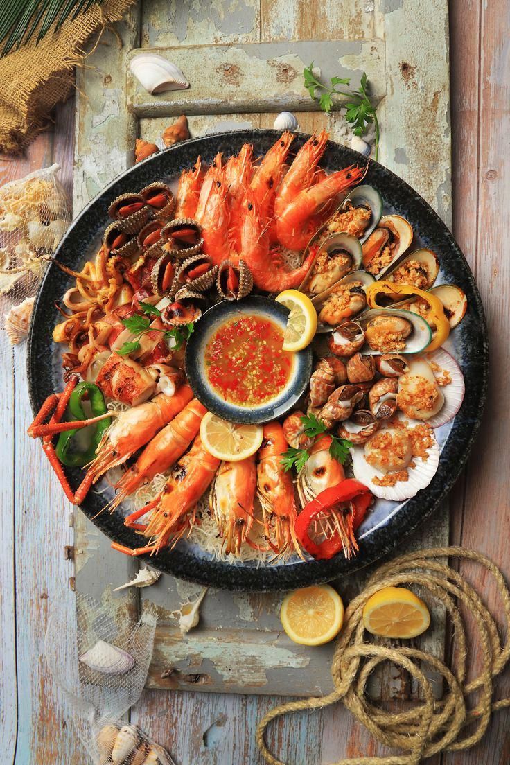 seafood platter with shrimp, scallops and oysters on an old wooden table