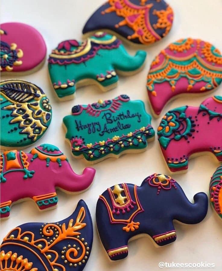 decorated cookies in the shape of elephants on a table