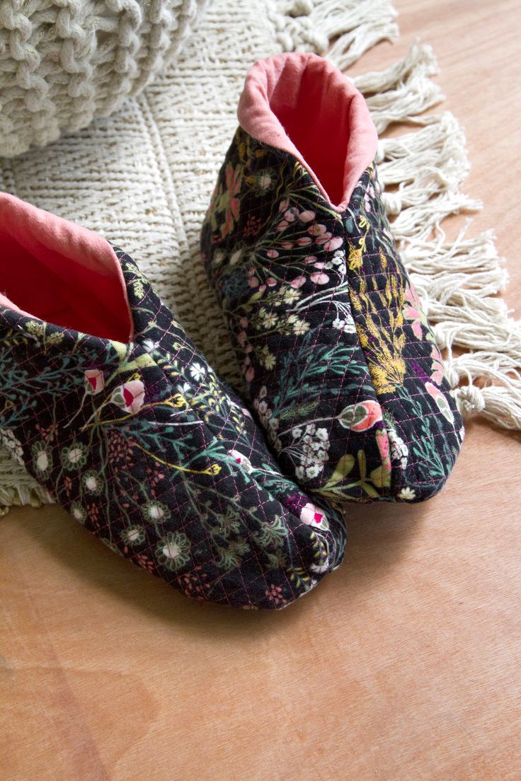 a pair of shoes sitting on top of a wooden floor next to a white rug