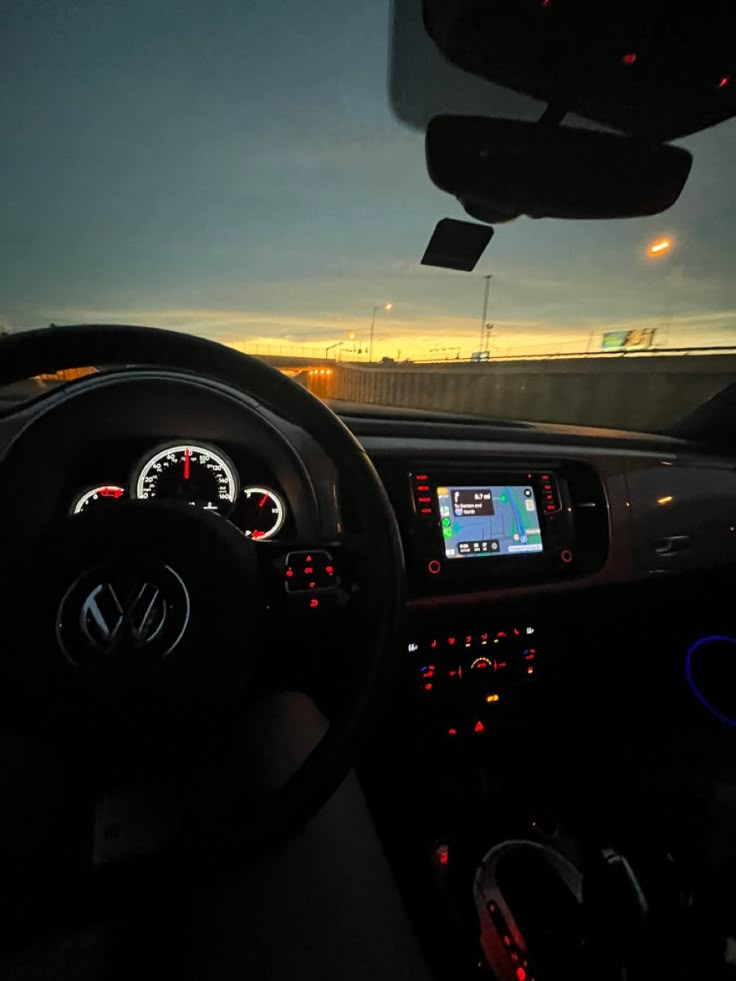 the dashboard of a car at night time