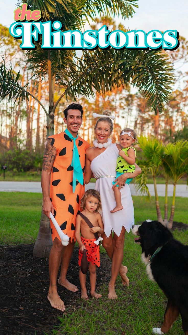 the flintstones movie poster with two adults and a child standing next to a dog