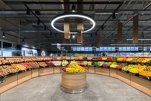 an empty grocery store filled with lots of fresh fruits and veggies on display