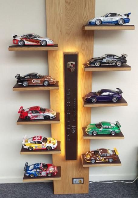 a wooden shelf with many cars on it