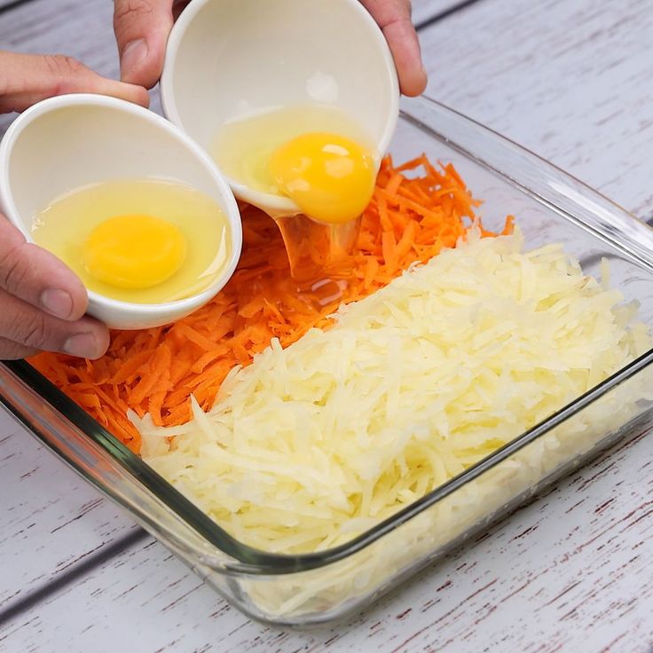 two eggs are being added to sauerkraut and shredded carrots