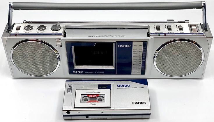 an old fashioned radio and cassette player sitting next to each other on a white surface