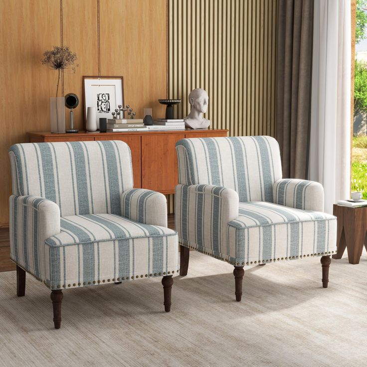 two striped chairs sitting in front of a window