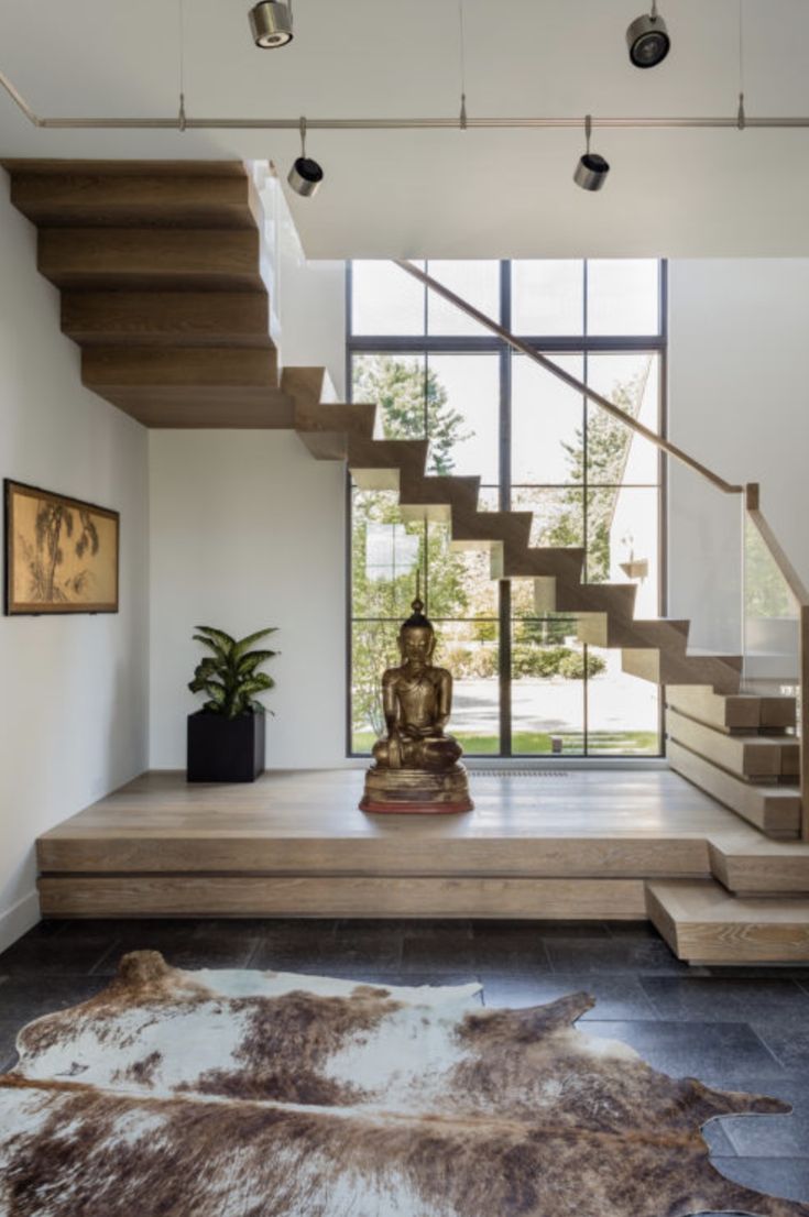 a living room filled with furniture and a stair case