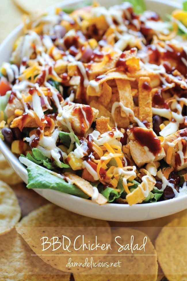 a white bowl filled with salad and tortilla chips on top of a table