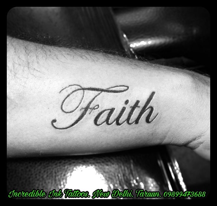 a man's arm with the word faith tattooed on it