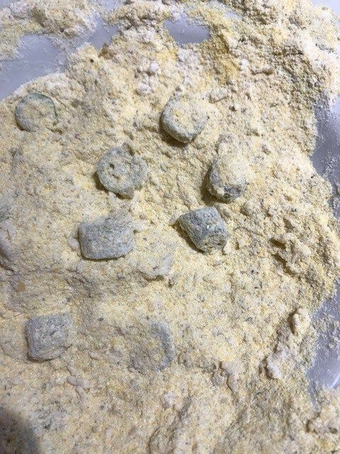 a bowl filled with flour and rocks on top of a table