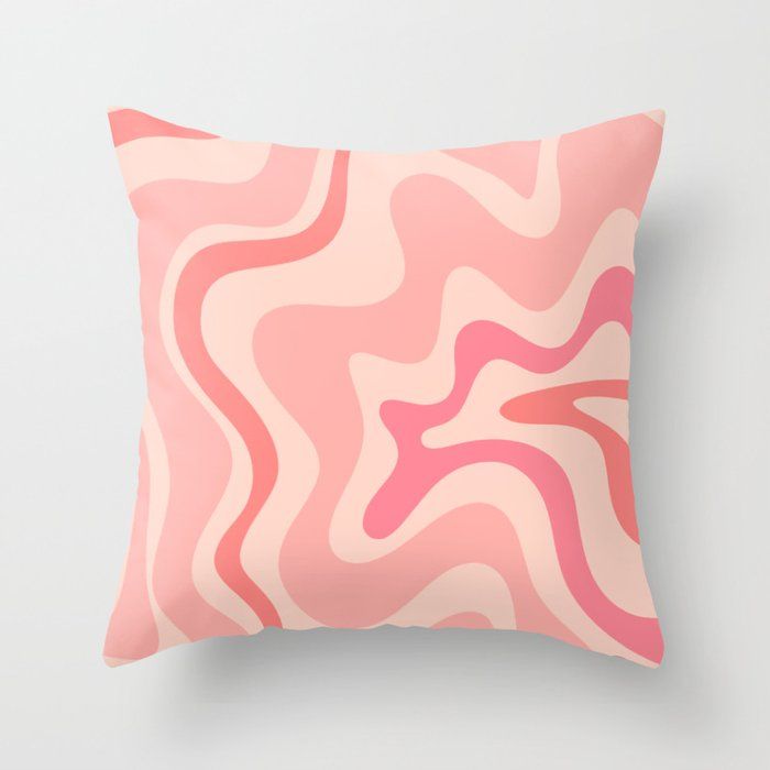 a pink and white pillow with wavy lines