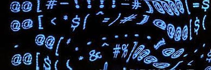 the numbers and symbols are projected in blue light on a black background with white writing