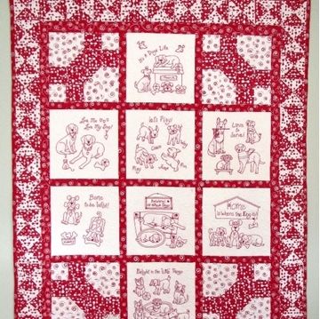 a red and white quilted wall hanging