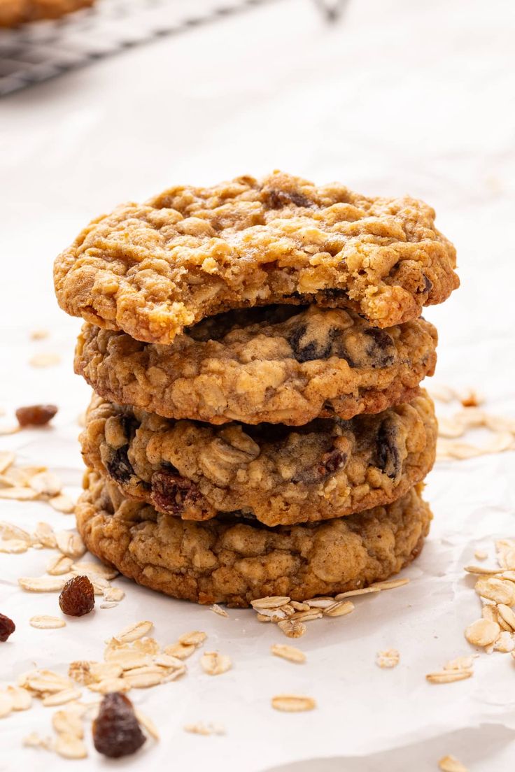 three oatmeal cookies stacked on top of each other with raisins