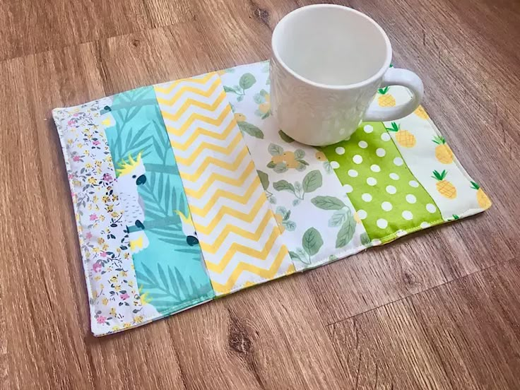 a coffee cup sitting on top of a place mat