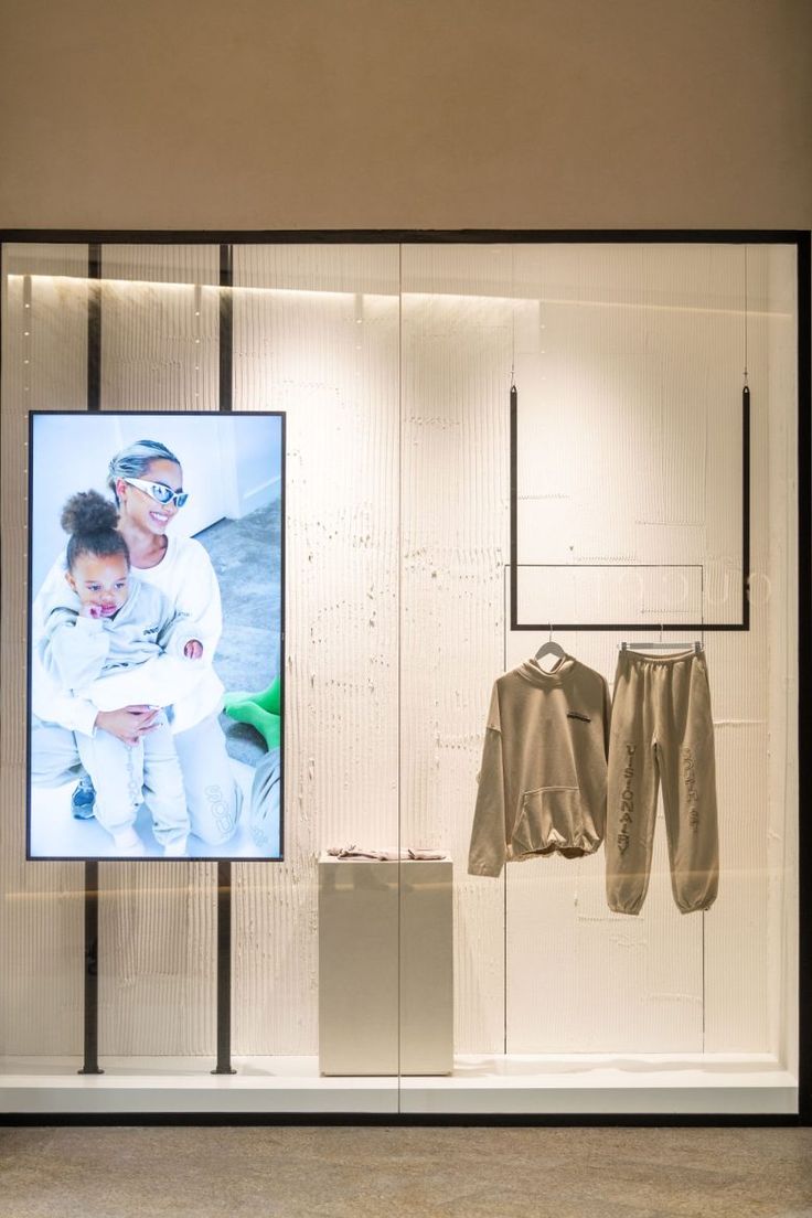 an image of a man holding a baby on display in a store window