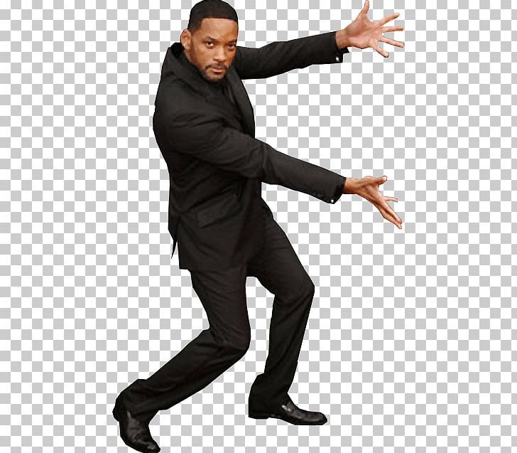 a man in a suit and tie is dancing with his hands out to the side