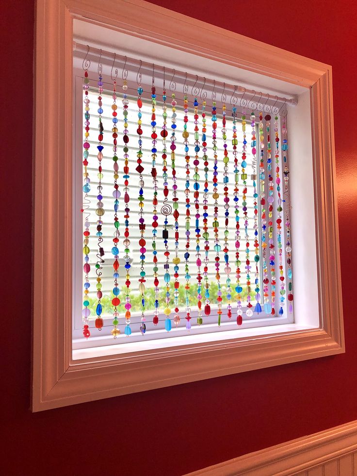 the window is decorated with colorful glass beads