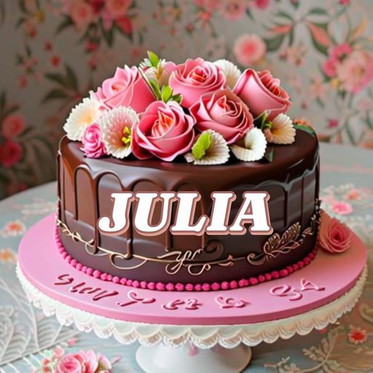 there is a chocolate cake with pink flowers on top and the name julia on it