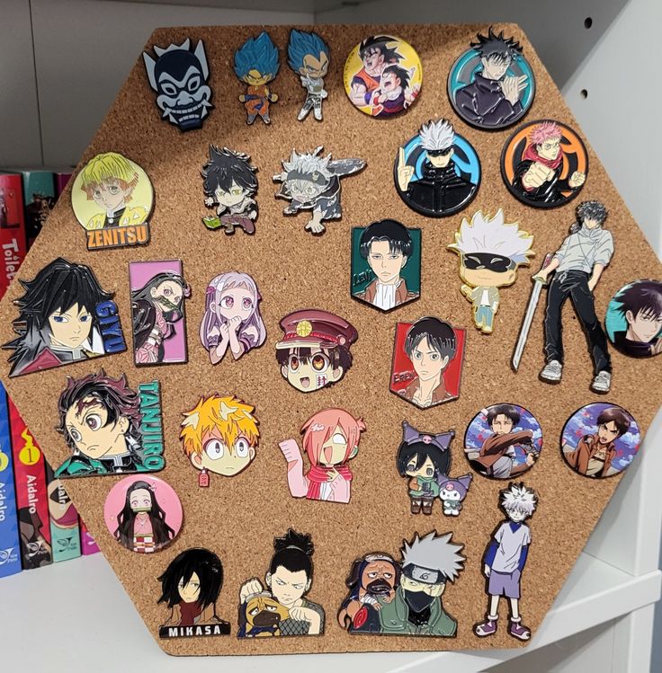 a cork board topped with lots of different anime pin's and magnets on top of it