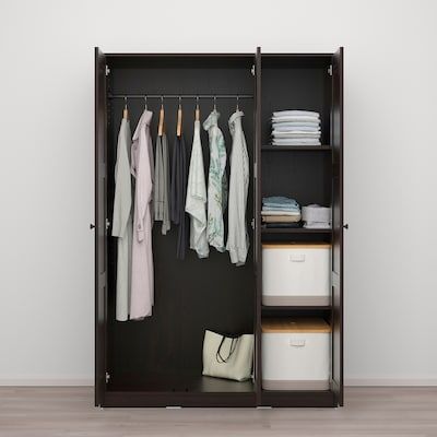 an open wardrobe with clothes hanging on it