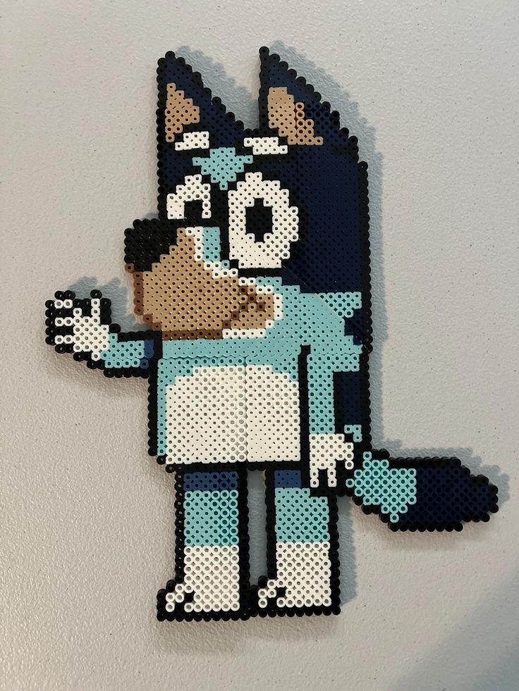 an image of a cartoon character made out of perler beads on a white wall