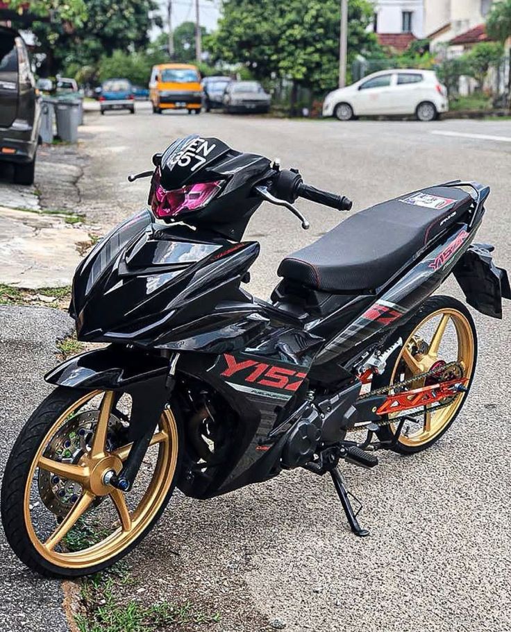 a black and gold motorcycle parked on the street