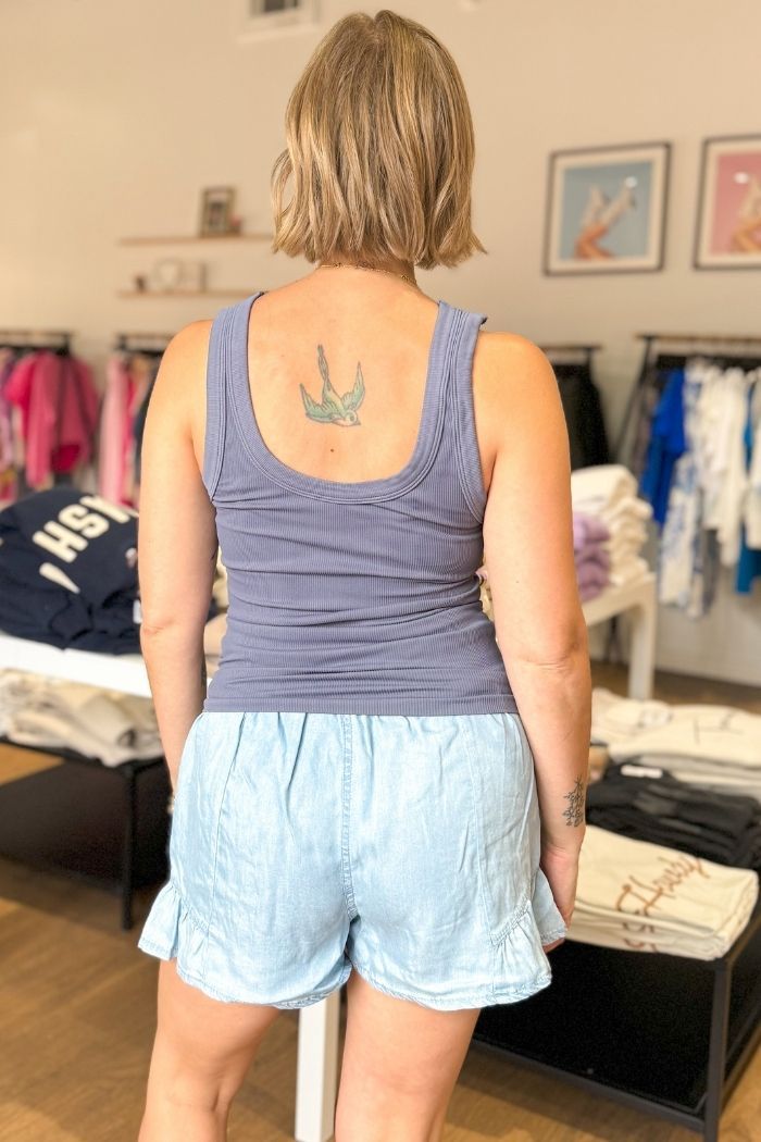 Get ready for twice the style with this reversible ribbed tank! Switch back and forth between a scoop neck and crew neck for any occasion. This seamless and versatile top works great for both activewear and layering under a jacket. Plus, you can pair it with leggings, joggers, denim, skirts, or trousers - the possibilities are endless! It's like having two tops in one! Model is wearing O/S: 5'2"Bust 34BWaist 26" Athleisure Scoop Neck Top For Layering, Athleisure Scoop Neck Tank Top For Layering, Sporty Scoop Back Tops For Spring, Ribbed Scoop Neck Athleisure Top, Spring Loungewear Tops With Scoop Back, Blue Tank Strap Top, Blue Tank Strap Top For Everyday, Scoop Back Tops For Spring Loungewear, Scoop Back Top For Spring Loungewear