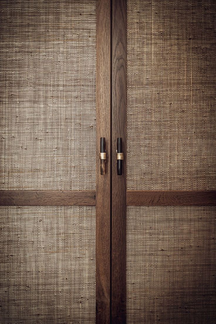 a close up of the handles on a wooden door