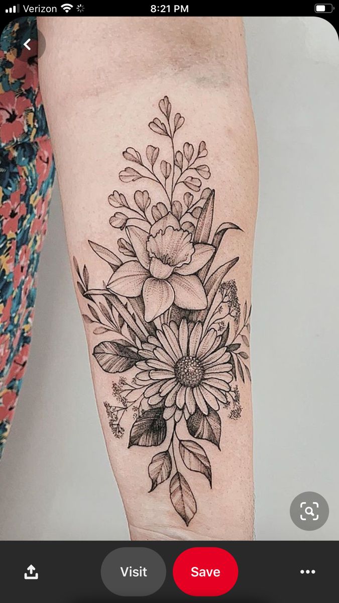 a woman's arm with a flower tattoo on it