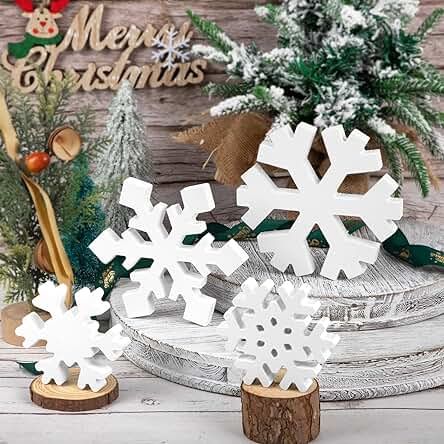 three snowflakes sitting on top of a wooden table next to evergreens and pine cones