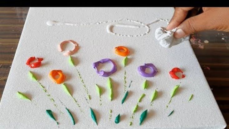 someone is making an art project with plastic flowers