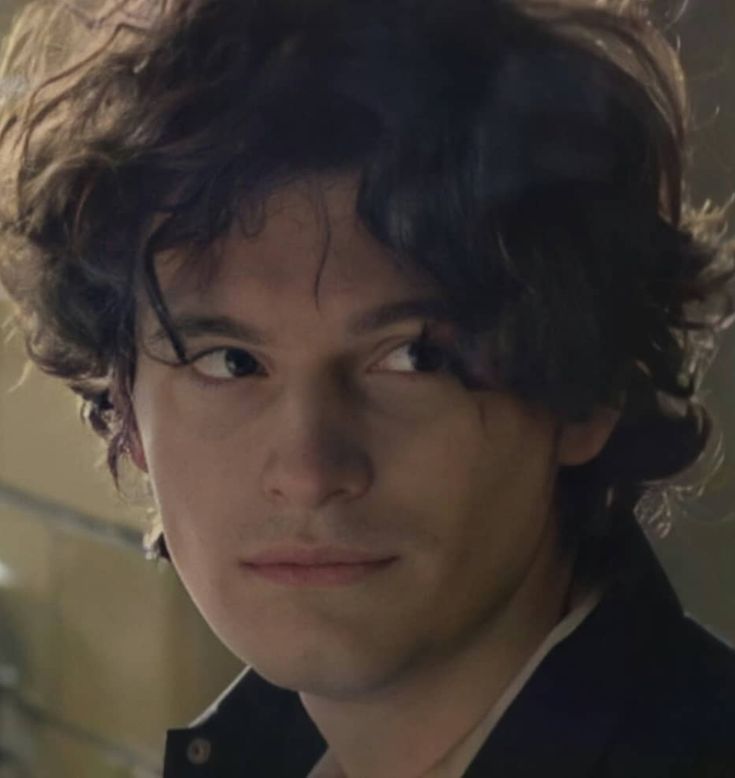 a close up of a person wearing a suit and tie looking at the camera with an intense look on his face