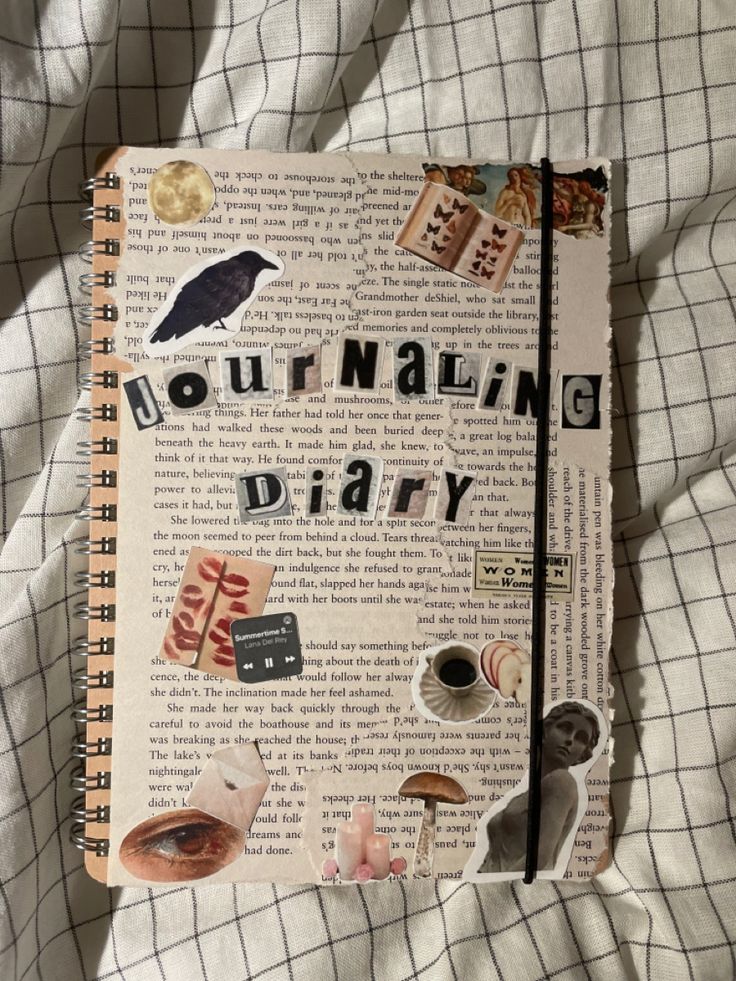 an open journal sitting on top of a bed