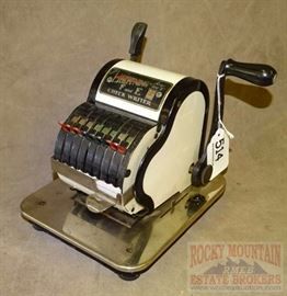 an old style cash register sitting on top of a metal plate with a black handle