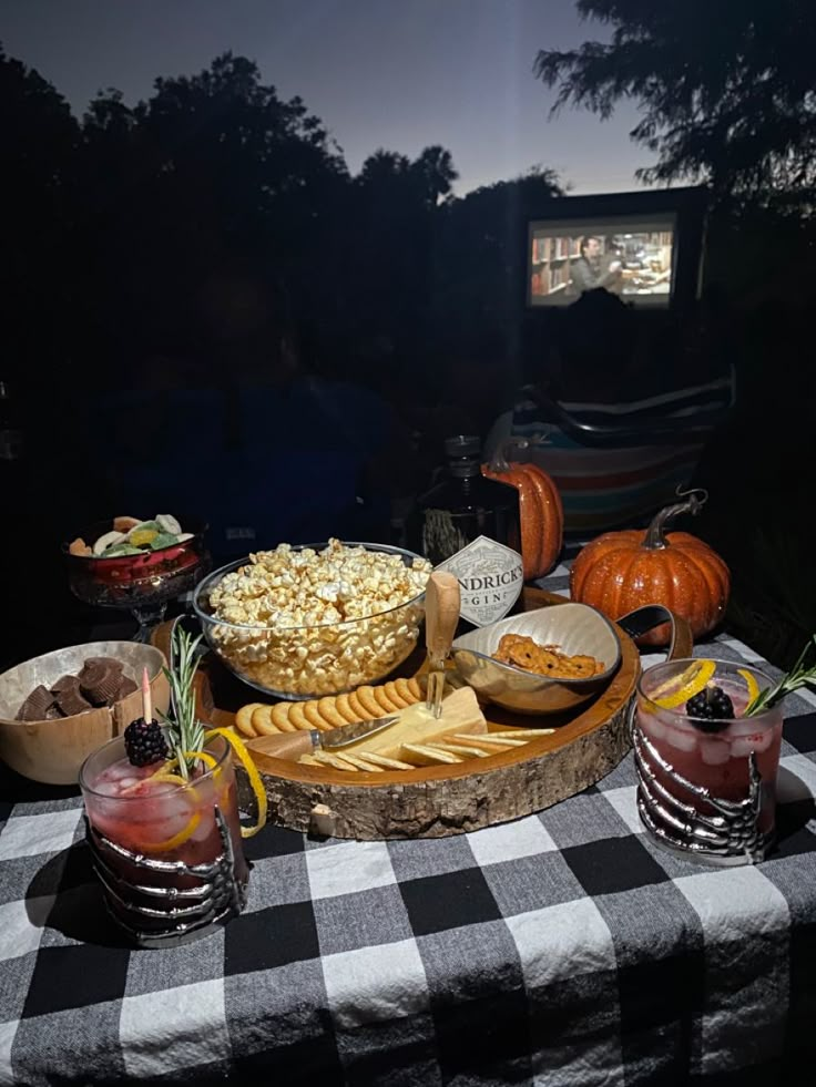 a table topped with cheese and crackers on top of a checkered table cloth