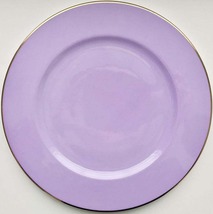 a purple plate with gold trim on the edge is shown in front of a white background