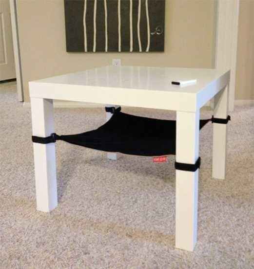 a white table with black straps on it in a living room next to a door