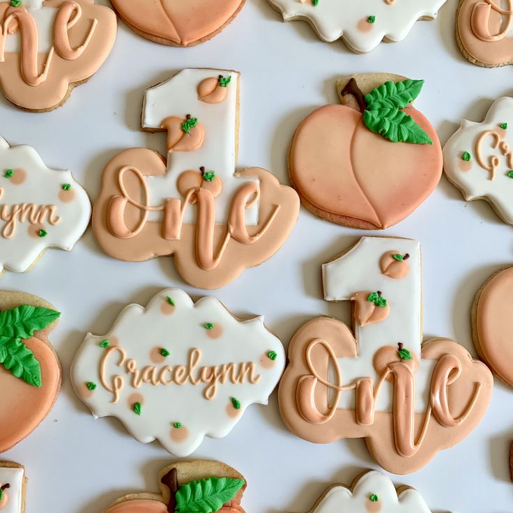 decorated cookies are arranged in the shape of pumpkins and one is for an 1st birthday